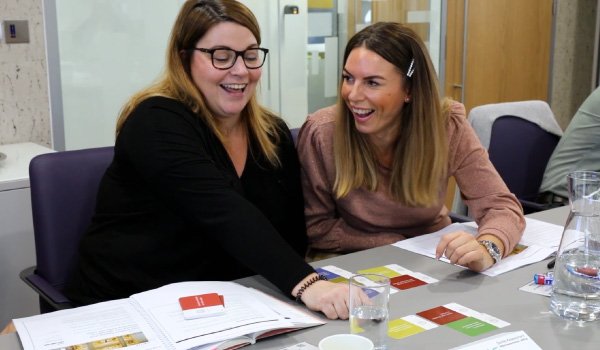 Two course delegates completing a card sort exercise