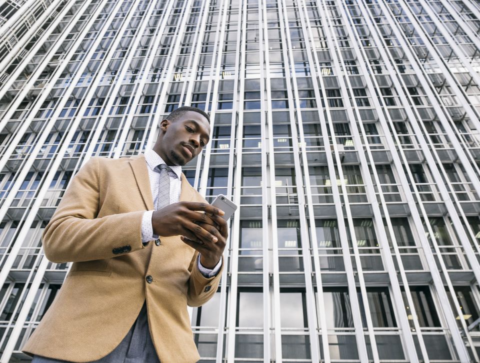 business man outside an office on his phone
