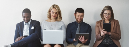 four people sitting in a row