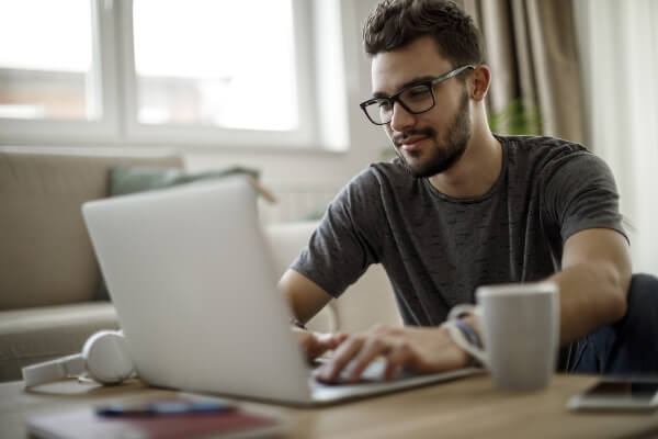 man typing on laptop