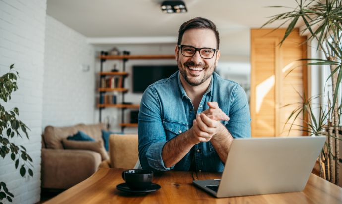ma clasping hands in front of a laptop